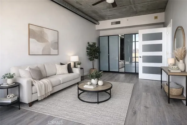 a living room with furniture and a potted plant