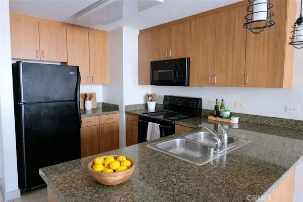 a kitchen with a refrigerator a stove a microwave and cabinets