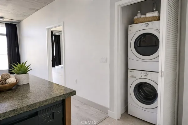 a view of a storage and utility room with washer and dryer