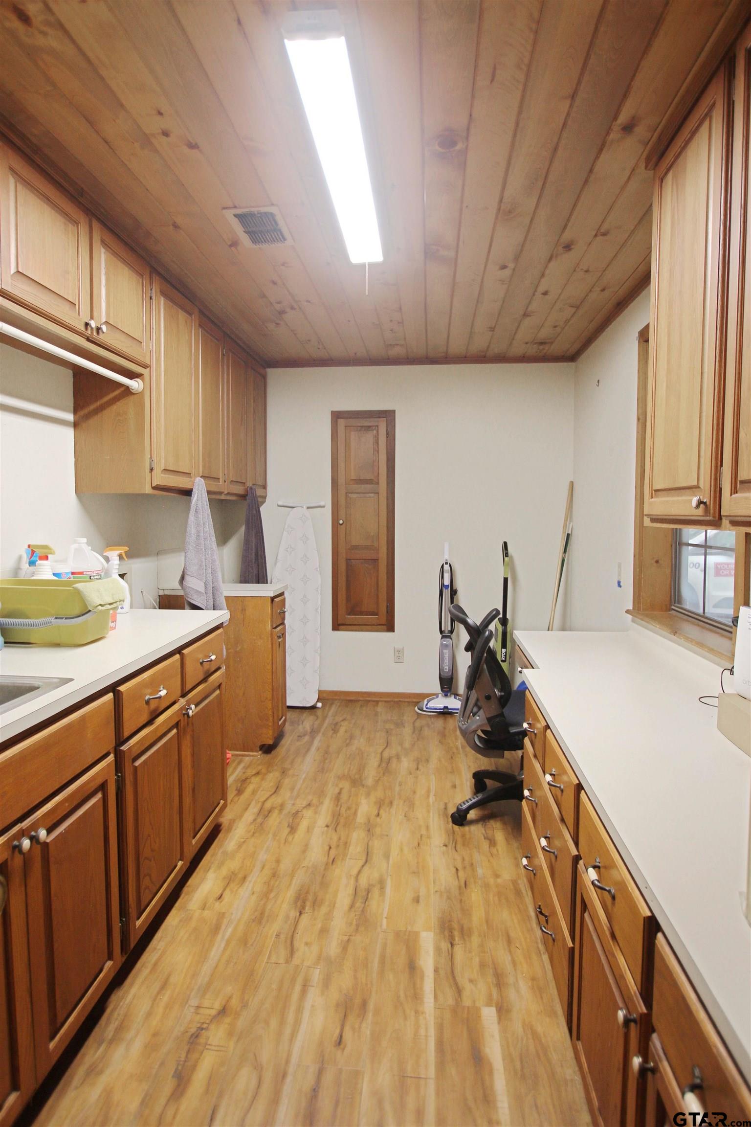 782 Rosie Wady Road Gladewater, TX 75647 - Photo 11 of 48 a kitchen with sink cabinets and wooden floor