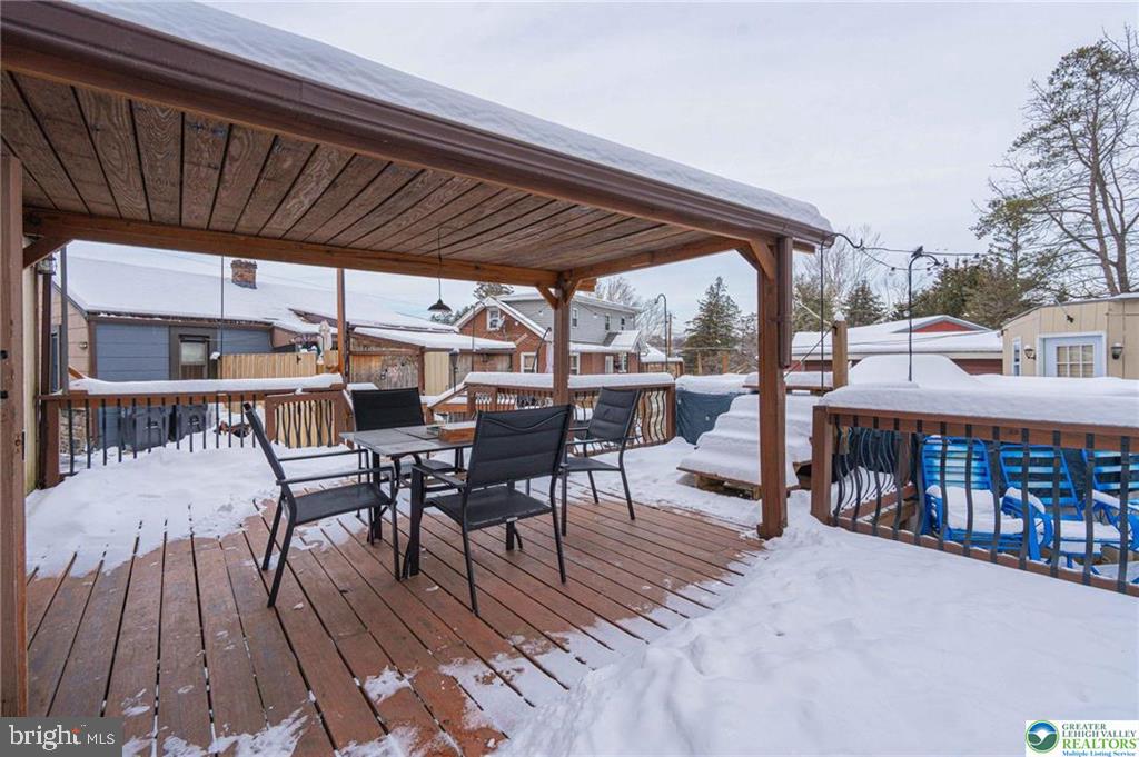 2303 South Filbert Street Allentown, PA 18103 - Photo 51 of 61 a view of a roof deck with table and chairs with wooden floor and fence