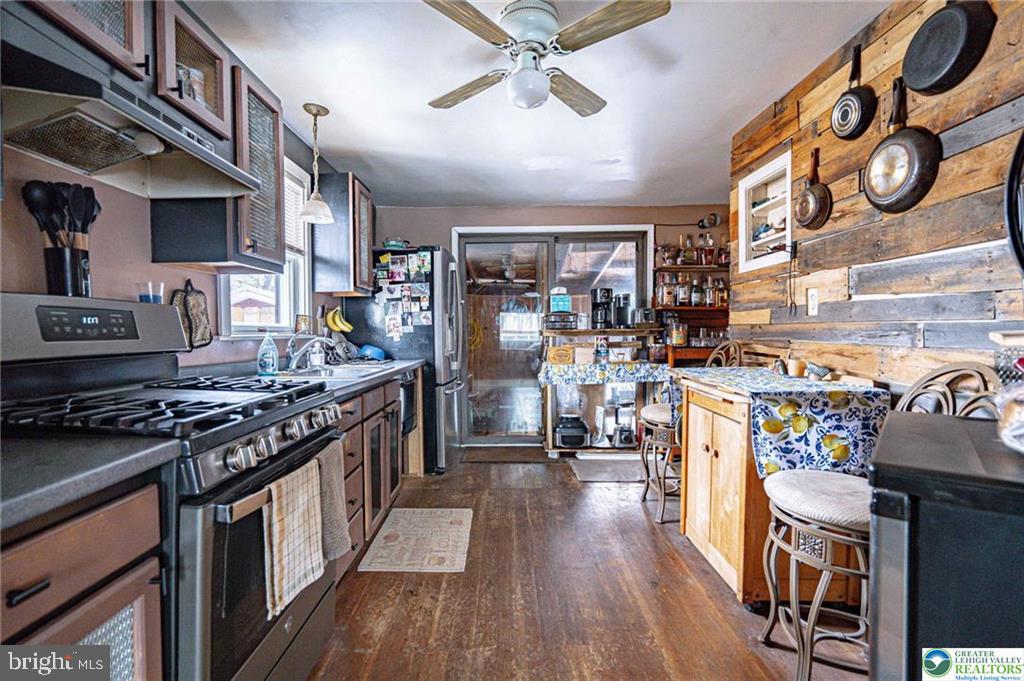 2303 South Filbert Street Allentown, PA 18103 - Photo 10 of 61 a kitchen with stainless steel appliances granite countertop a stove and cabinets
