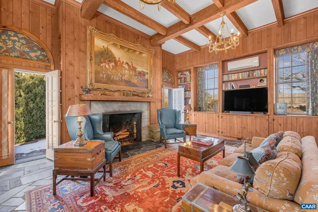 a living room with furniture and a book shelf