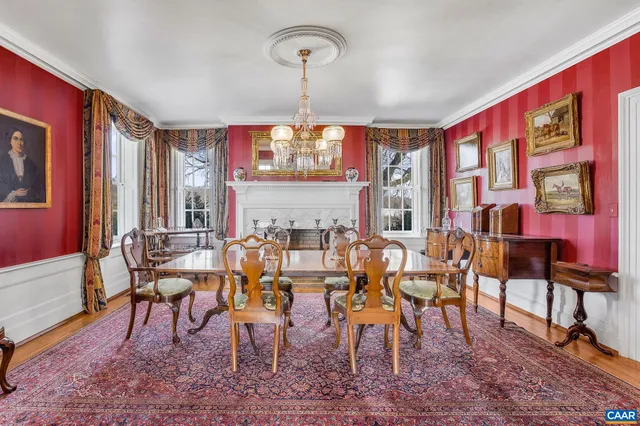 a dining room with furniture a chandelier and wooden floor