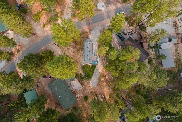 an aerial view of a house with yard