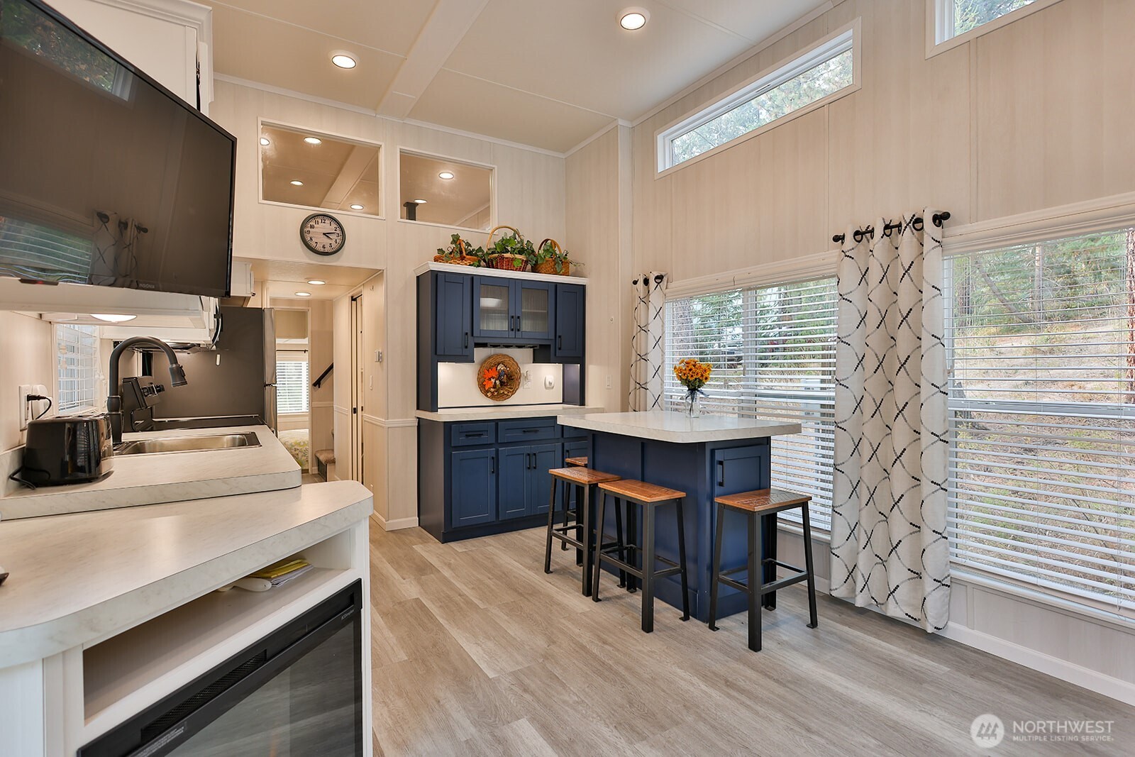 21512 Camp 12 Road Leavenworth, WA 98826 - Photo 6 of 40 a kitchen with stainless steel appliances kitchen island granite countertop a table chairs in it and wooden floors