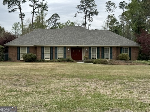 410 Preston Street Metter, GA 30439 - Photo 2 of 39 a front view of a house with a garden
