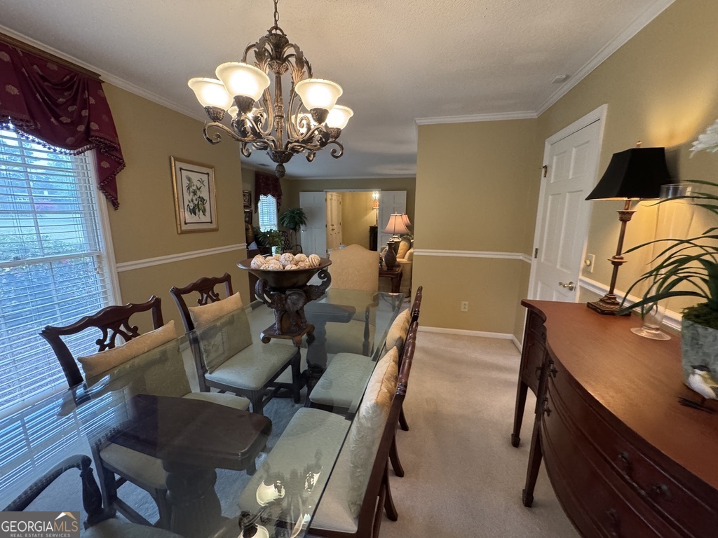 410 Preston Street Metter, GA 30439 - Photo 22 of 39 a view of a dining room with furniture and a chandelier