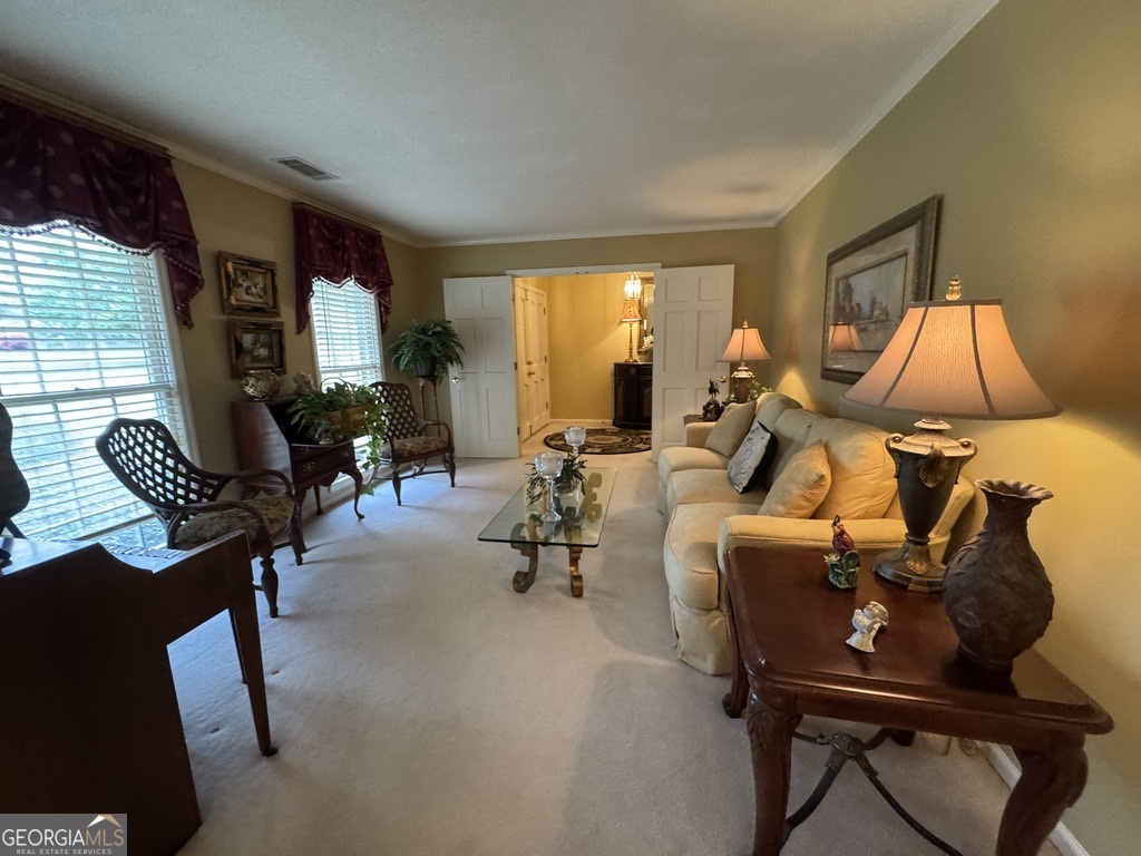 410 Preston Street Metter, GA 30439 - Photo 24 of 39 a room with furniture and a large window
