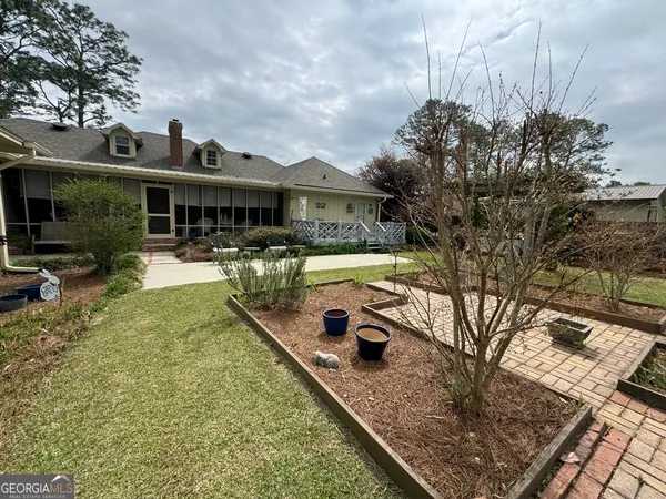 a view of a house with swimming pool and sitting area