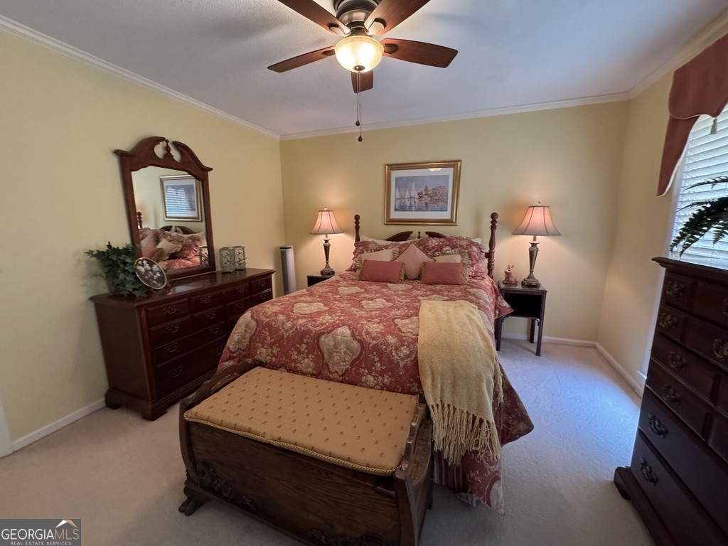 410 Preston Street Metter, GA 30439 - Photo 31 of 39 a bedroom with a bed and a chandelier