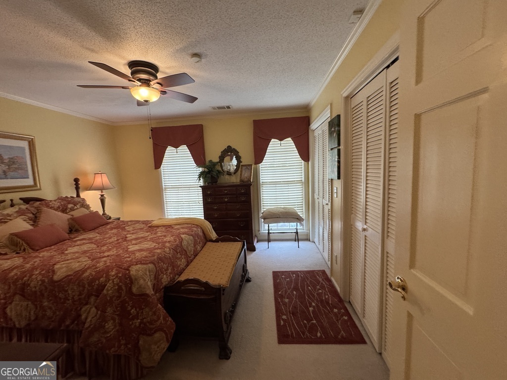 410 Preston Street Metter, GA 30439 - Photo 32 of 39 a bedroom with a bed and a chandelier