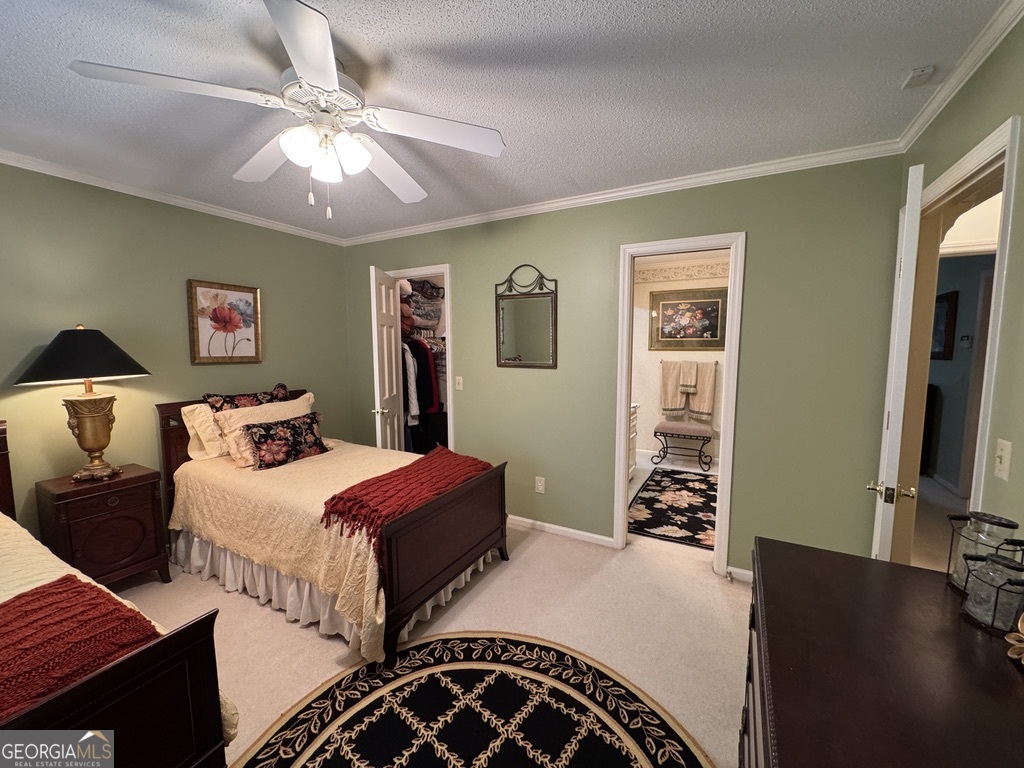 410 Preston Street Metter, GA 30439 - Photo 34 of 39 a bedroom with double bed and a chandelier