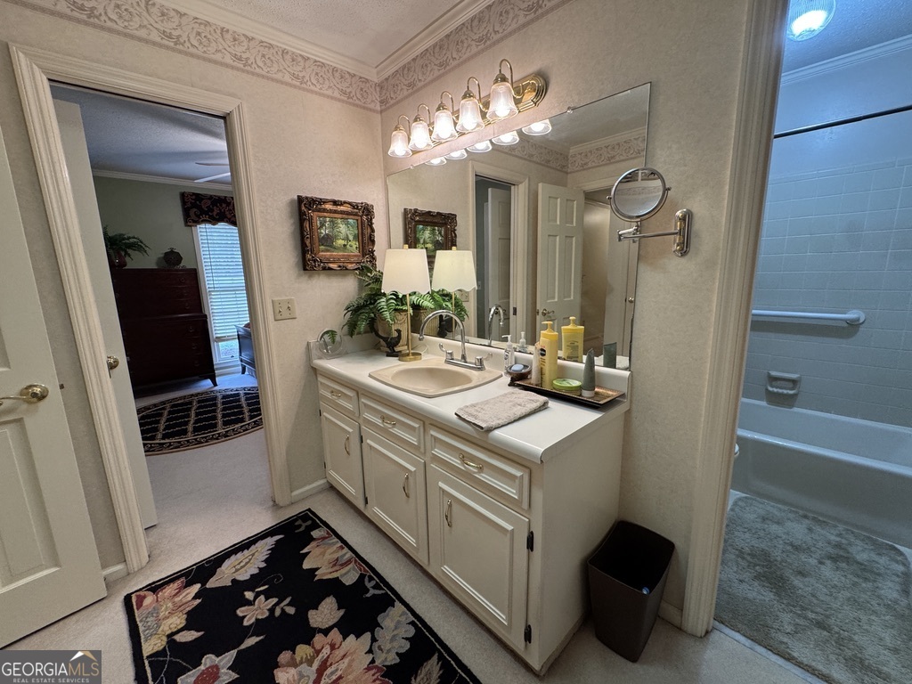 410 Preston Street Metter, GA 30439 - Photo 36 of 39 a bathroom with a sink a mirror and a shower