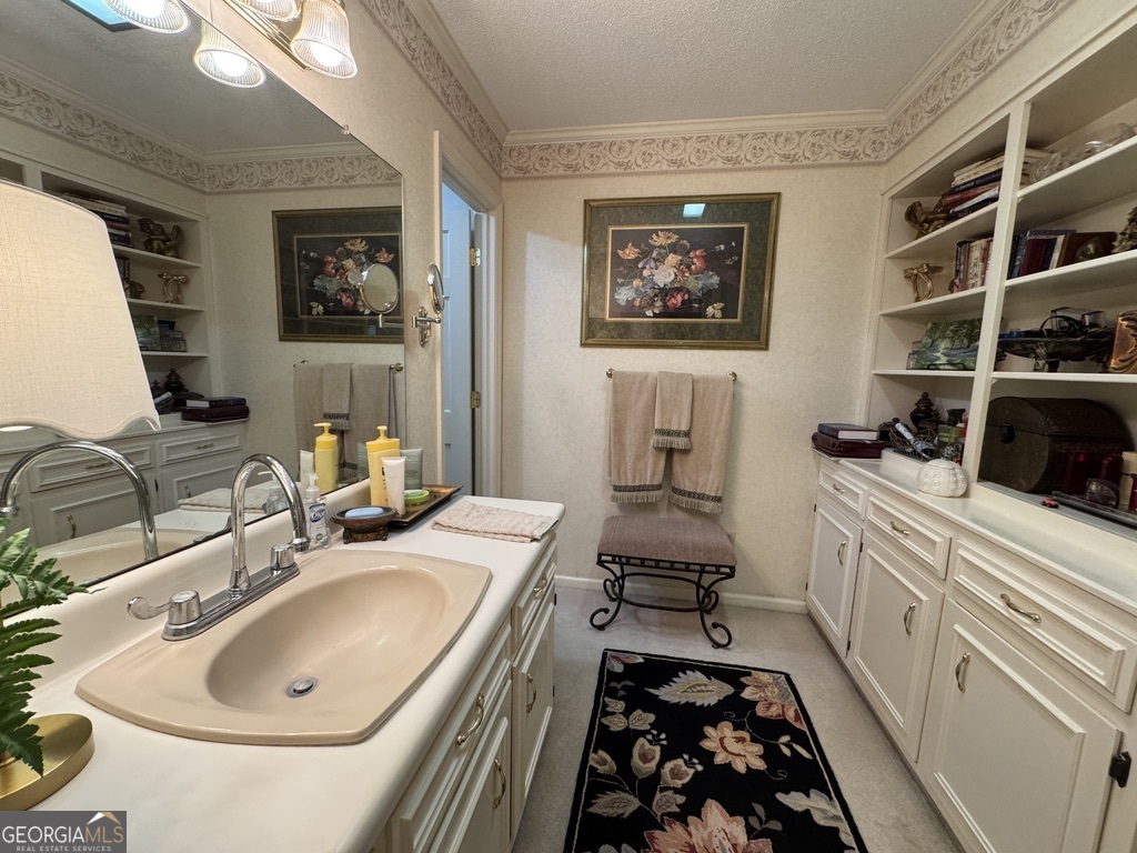 410 Preston Street Metter, GA 30439 - Photo 37 of 39 a bathroom with a double vanity sink and a mirror