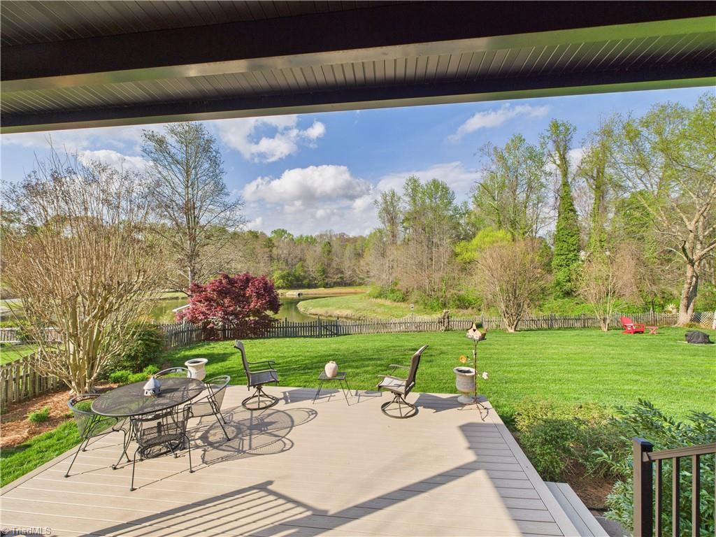 4212 Suffolk Trail Greensboro, NC 27407 - Photo 22 of 40 You can't imagine how serene this amazing backyard is!!! A double deck looking back onto a natural area and pond.