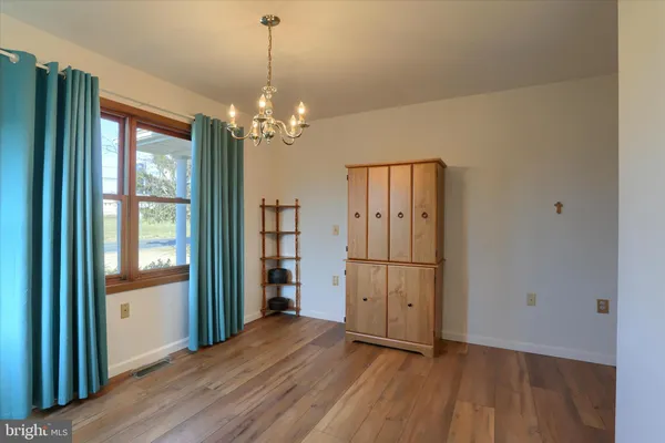 a view of a room with wooden floor and windows