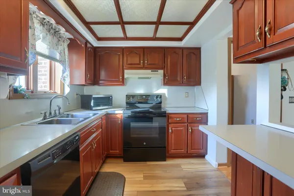 a kitchen with stainless steel appliances granite countertop a stove sink and cabinets