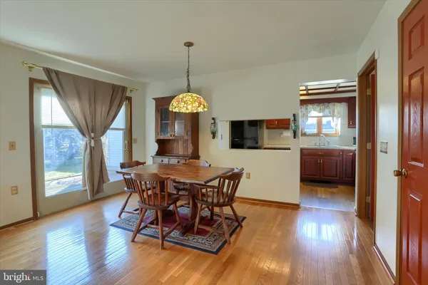 a view of a dining room with furniture window and wooden floor