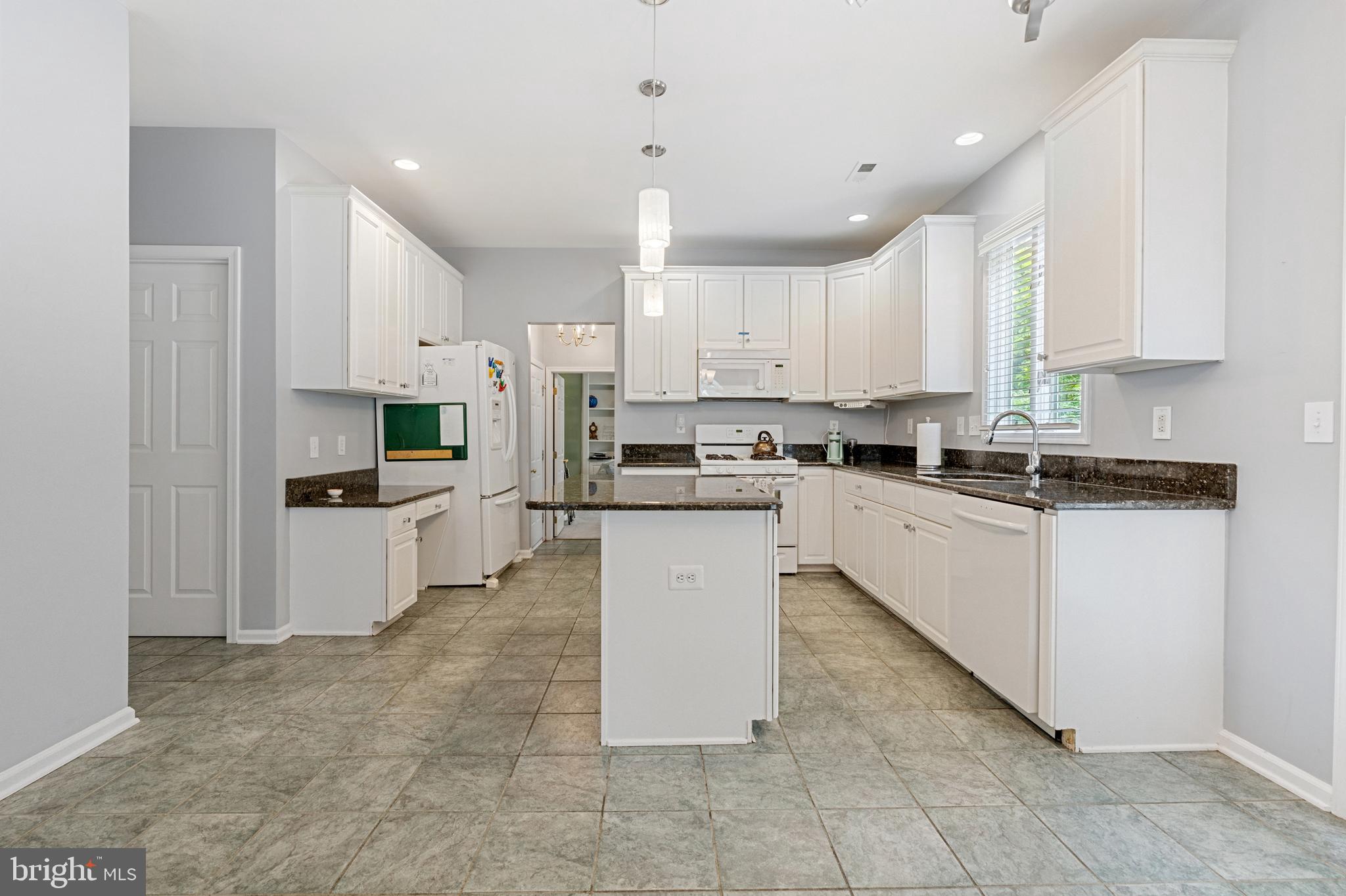4913 Mead Drive Doylestown, PA 18902 - Photo 11 of 41 a kitchen with kitchen island granite countertop a stove top oven a sink a counter top space and cabinets