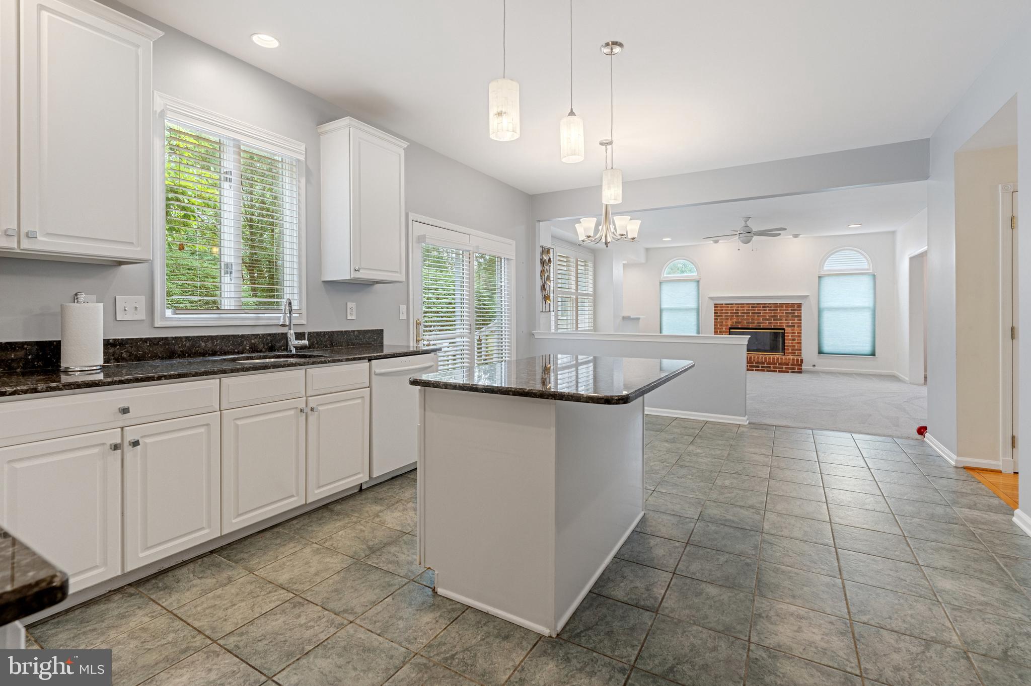 4913 Mead Drive Doylestown, PA 18902 - Photo 13 of 41 a kitchen with kitchen island granite countertop a sink cabinets and window