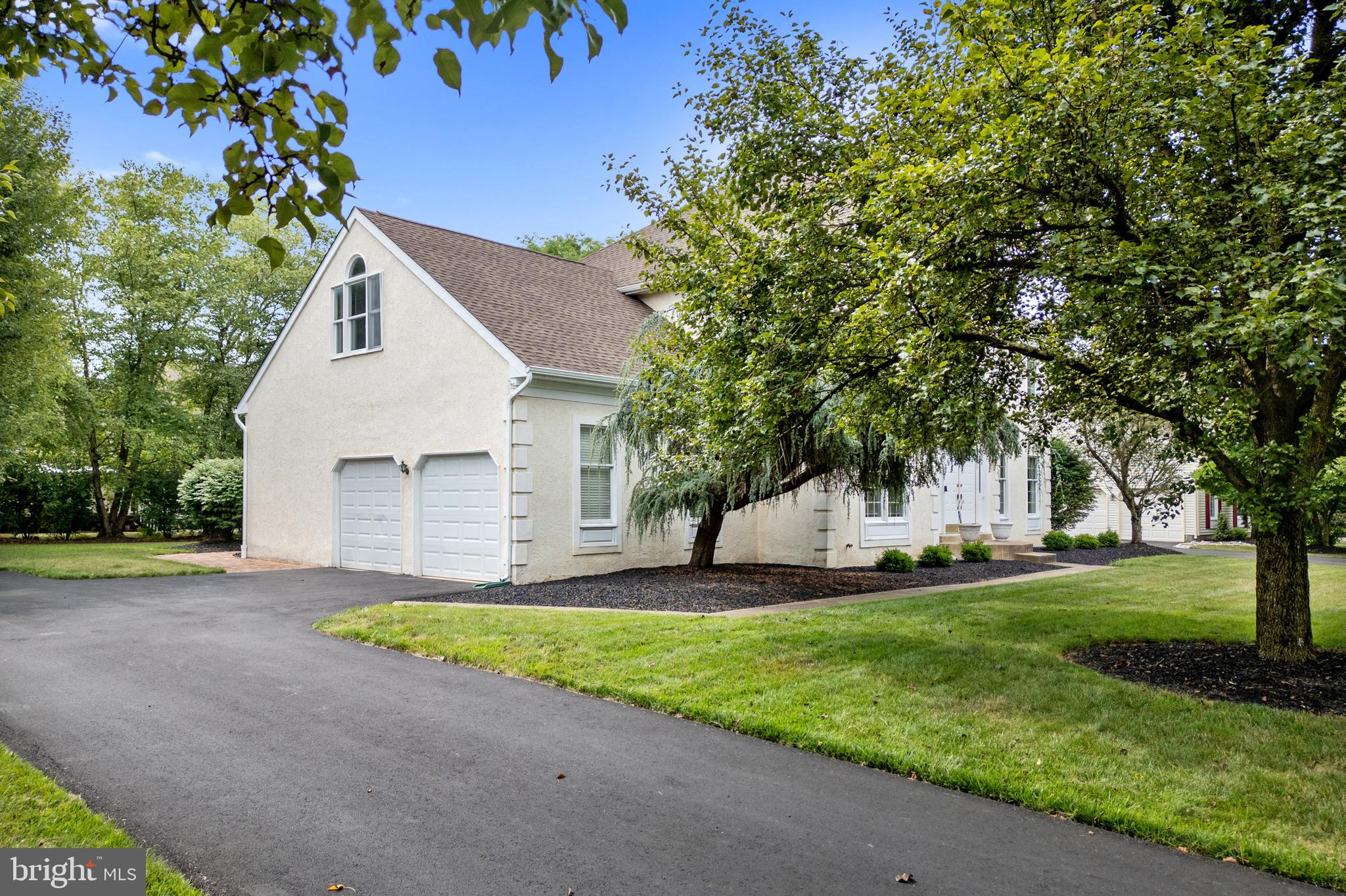 4913 Mead Drive Doylestown, PA 18902 - Photo 2 of 41 a front view of a house with a yard and garage