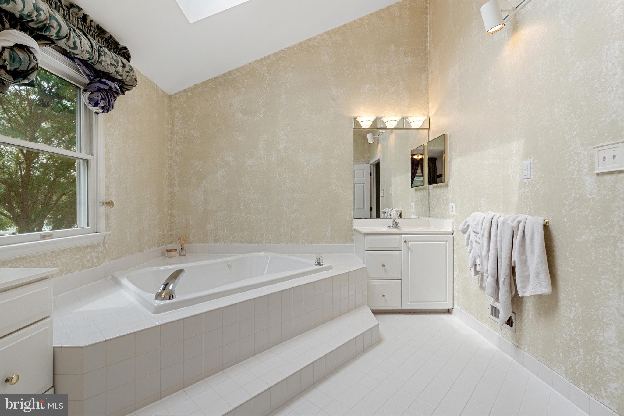 4913 Mead Drive Doylestown, PA 18902 - Photo 22 of 41 a bathroom with a tub sink and mirror