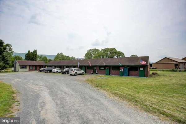 an outdoor view of house with yard and mountain view in back