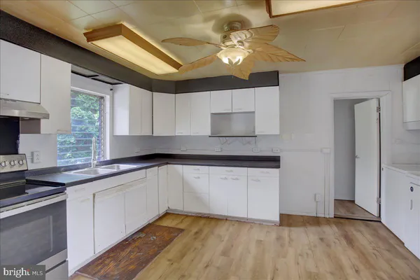 a room view with wooden floor and cabinets