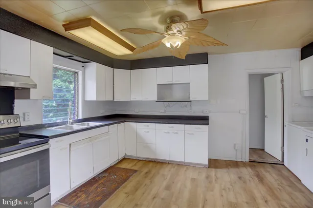 a room view with wooden floor and cabinets