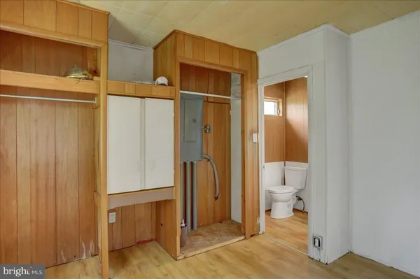 a bathroom with a granite countertop sink and a toilet