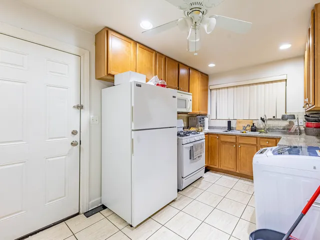 a kitchen with sink cabinets and refrigerator