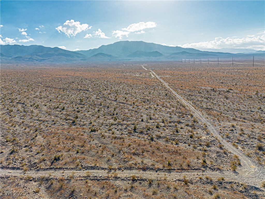 7030 North Koala Road Pahrump, NV 89060 - Photo 7 of 9 Aerial view of sparsely populated area featuring a mountainous background and a desert landscape