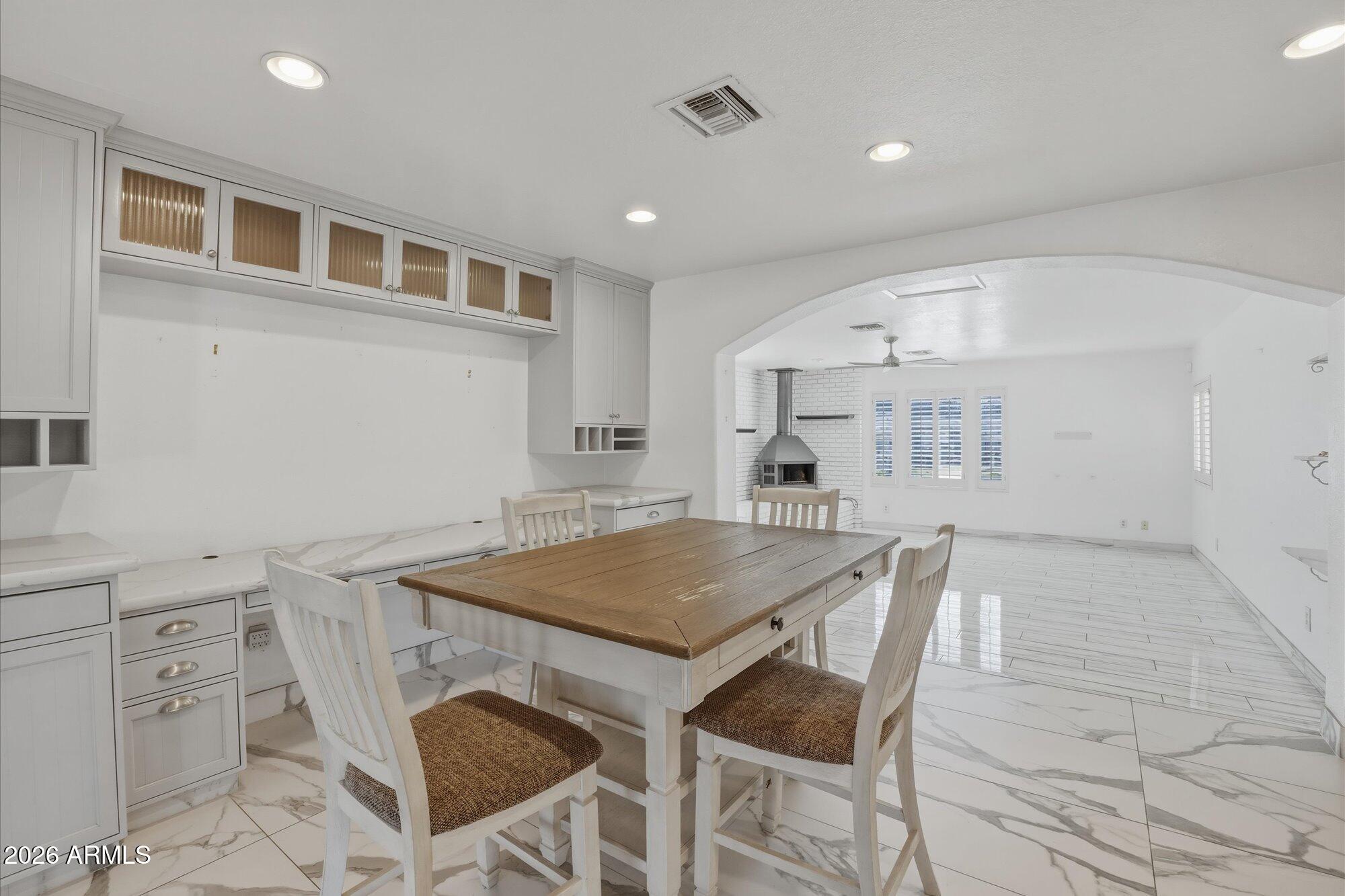 1532 West Loma Lane Phoenix, AZ 85021 - Photo 5 of 19 a kitchen with a table chairs and a refrigerator