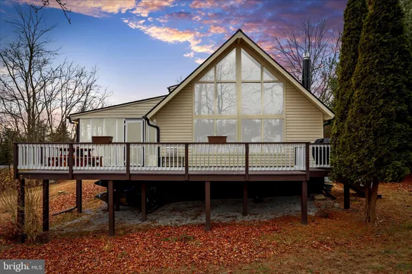 a living room with furniture a fireplace and a large window