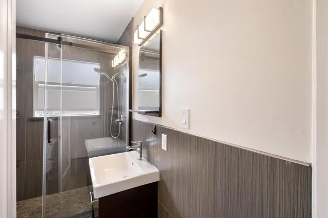 a bathroom with a sink vanity and a mirror