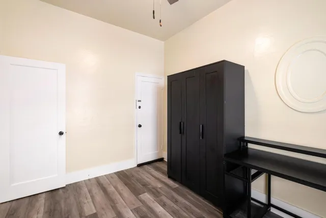 a view of a hallway with wooden floor