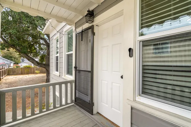 a view of a balcony with wooden floor and door