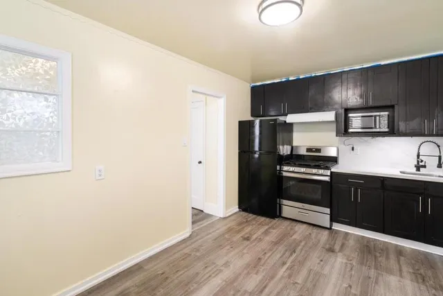 a kitchen with a refrigerator and a sink