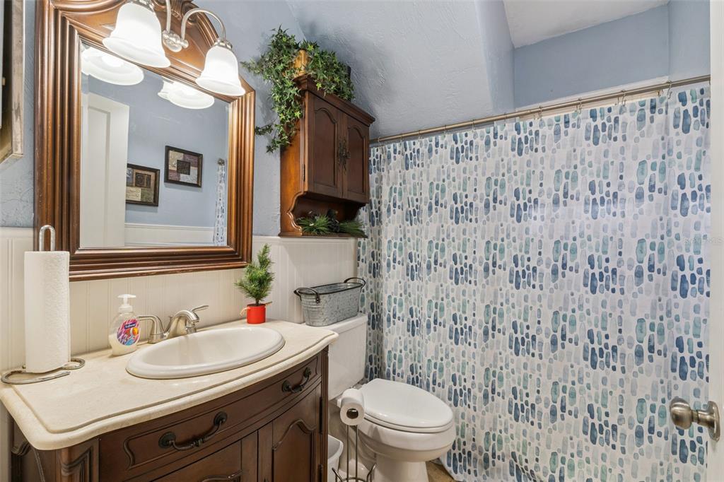 3828 Walker Road Apopka, FL 32703 - Photo 14 of 34 a bathroom with a sink a toilet and a mirror