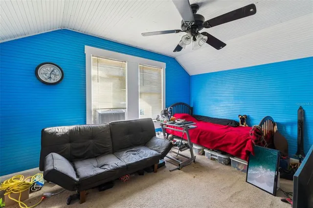 a living room with furniture a air conditioner and a large window