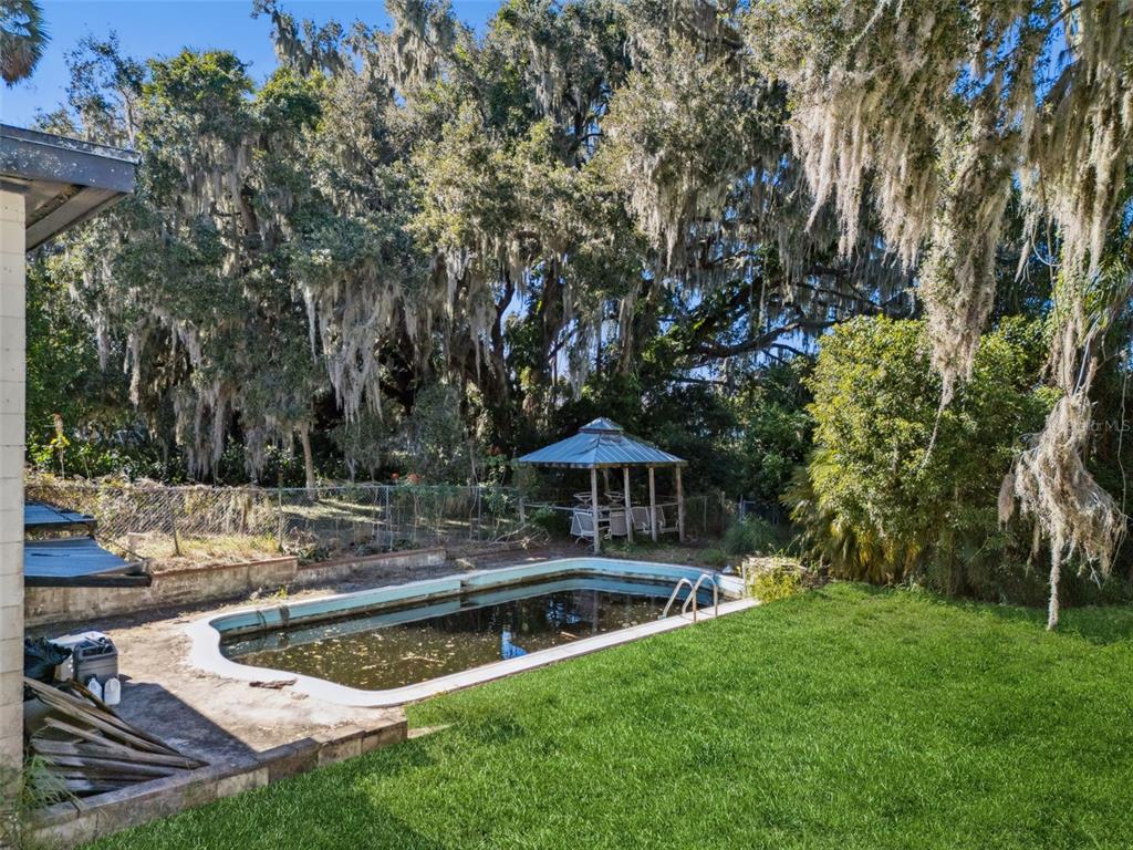 3828 Walker Road Apopka, FL 32703 - Photo 22 of 34 a view of a house with swimming pool and sitting area