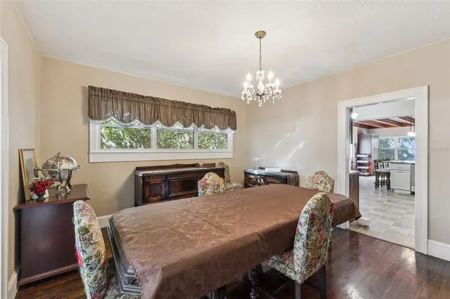 a view of a dining room with furniture wooden floor and chandelier
