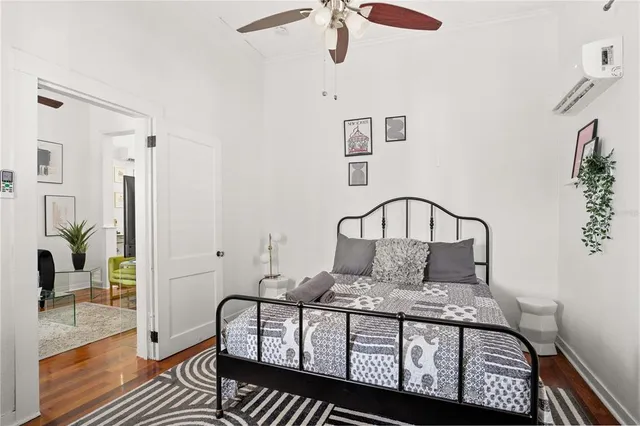 a bedroom with a bed window and a potted plant