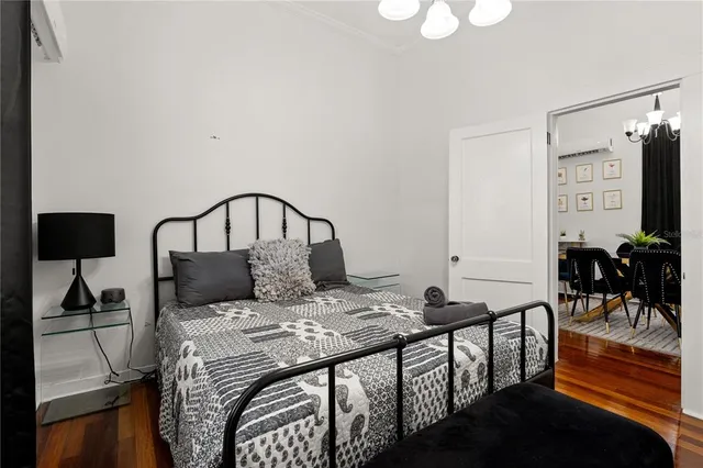 a bedroom with a bed and view of living room