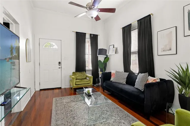 a living room with furniture and wooden floor