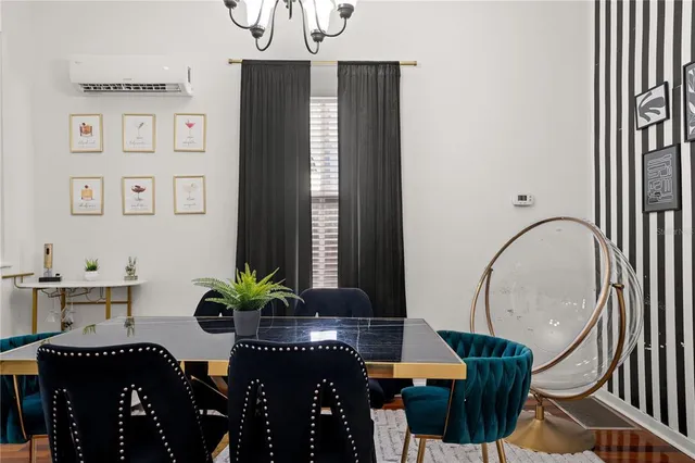 a dining room with furniture and a potted plant