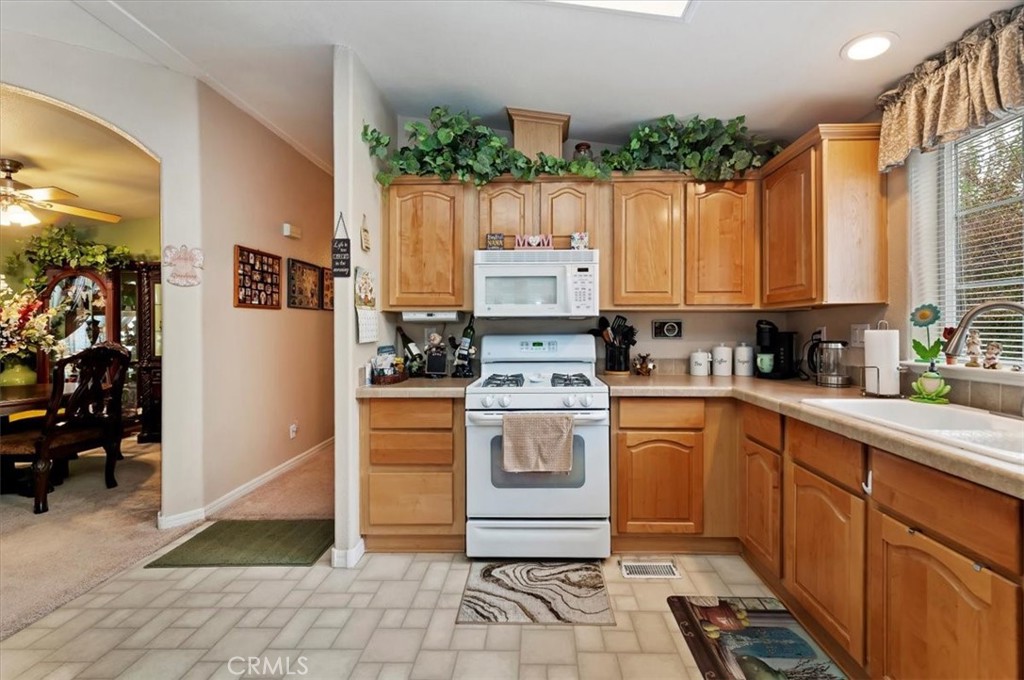 31130 South General Kearny Road, Unit 147 Temecula, CA 92591 - Photo 5 of 42 a kitchen with stainless steel appliances a stove a sink and cabinets