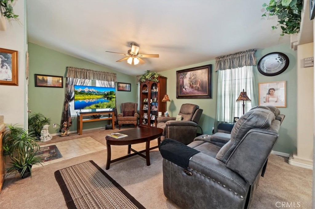 31130 South General Kearny Road, Unit 147 Temecula, CA 92591 - Photo 7 of 42 a living room with furniture a bookshelf and a window