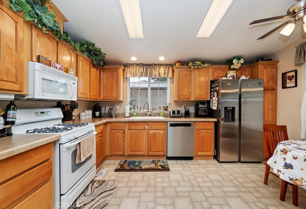 31130 South General Kearny Road, Unit 147 Temecula, CA 92591 - Photo 9 of 42 a large kitchen with stainless steel appliances granite countertop a stove a sink and a refrigerator